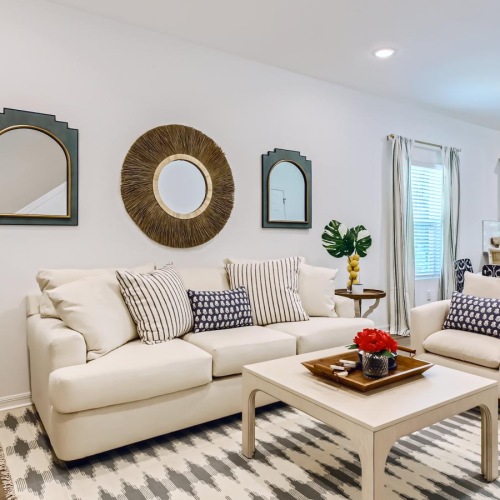 Wide open living areas perfect for entertaining a living room with a white couch and a coffee table