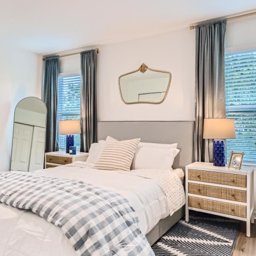 Relax and recharge in beautiful and spacious bedrooms a bedroom with a bed and a plant